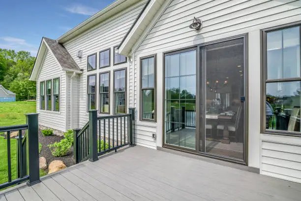 Sliding glass patio door opening onto a gray composite deck