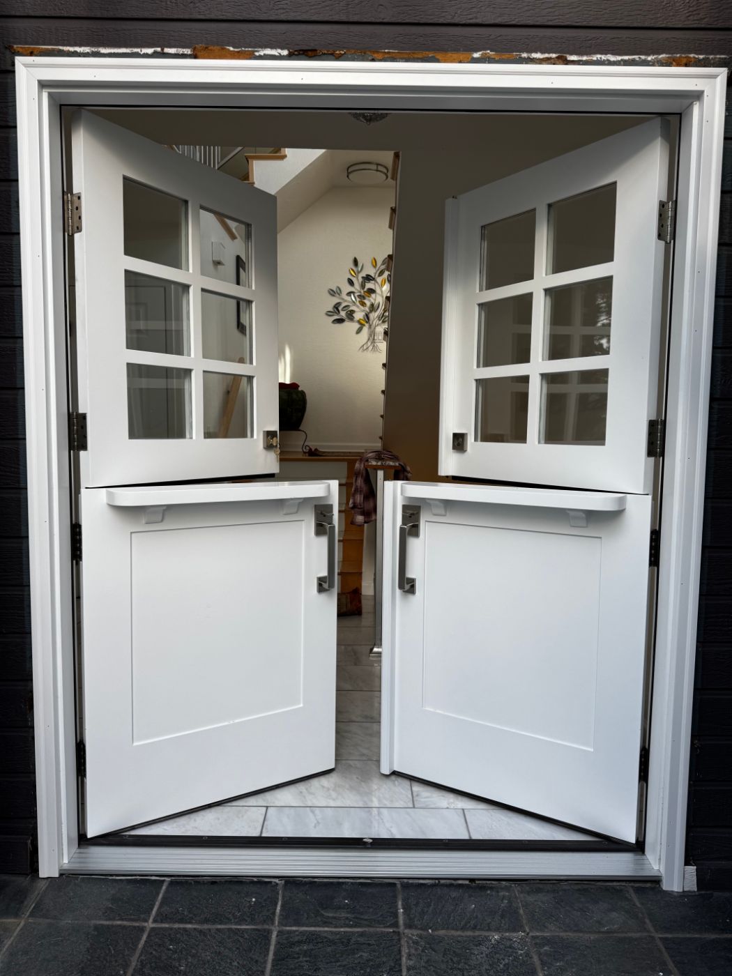 White double Dutch doors with divided glass tops, both halves open