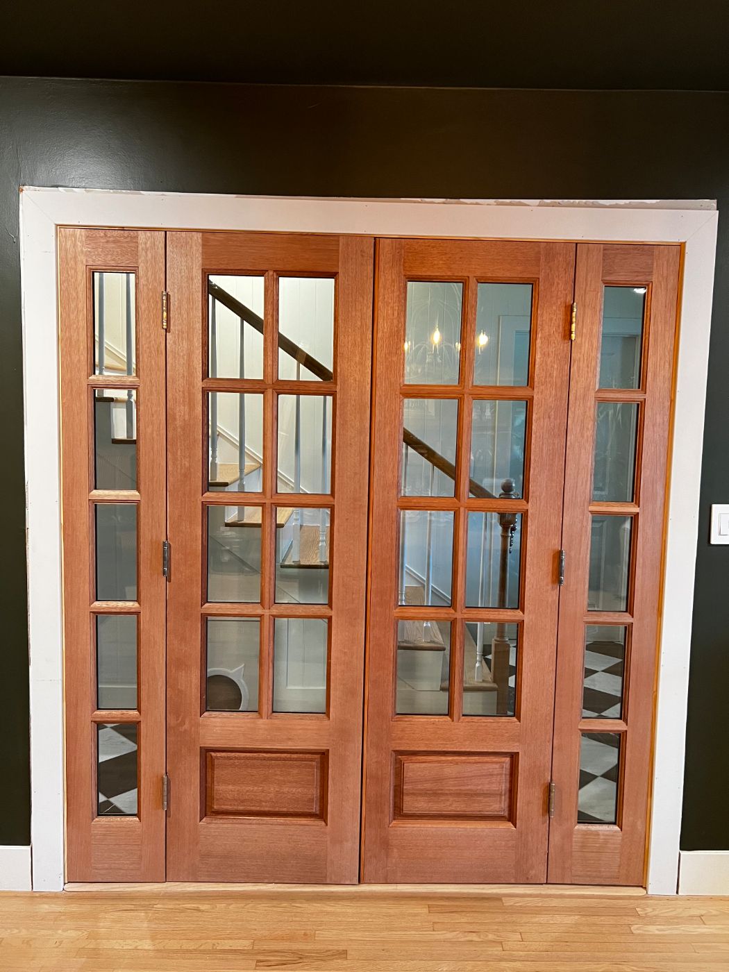 Mahogany French doors with matching divided-lite sidelites in an interior opening