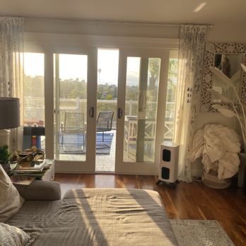 White sliding patio doors opening to a sunny balcony